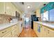 Kitchen with white appliances, lots of cabinets, and laminate countertops at 881 Grado Dr, Venice, FL 34285