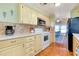 Bright kitchen with essential appliances, laminate countertops and open dining area view at 881 Grado Dr, Venice, FL 34285