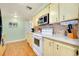 Functional kitchen with white appliances, light wood cabinets, and laminate countertops at 881 Grado Dr, Venice, FL 34285