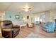 Bright living room with comfortable seating, ceiling fan, and access to sunroom at 881 Grado Dr, Venice, FL 34285