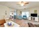 Inviting living room with wood floors, comfortable seating and an adjacent screened lanai at 881 Grado Dr, Venice, FL 34285