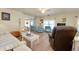Inviting living room with ceiling fan, access to sunroom, and laminate flooring at 881 Grado Dr, Venice, FL 34285