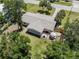 An aerial view of the home and private backyard with patio and mature trees at 929 Cypress Ave, Venice, FL 34285