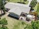 Aerial view of the property, showcasing the backyard patio, lush greenery, and nearby surroundings at 929 Cypress Ave, Venice, FL 34285