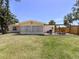 Spacious backyard with a covered patio, outdoor seating, and a grill, perfect for entertaining at 929 Cypress Ave, Venice, FL 34285
