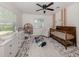 Charming Bedroom with a wooden crib, a changing table, and plenty of natural light at 929 Cypress Ave, Venice, FL 34285