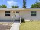 Charming home featuring a welcoming front door with decorative seahorse accents on the porch at 929 Cypress Ave, Venice, FL 34285