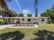 Charming single-story home with a covered carport and a well-manicured front lawn at 929 Cypress Ave, Venice, FL 34285