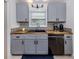 Updated kitchen features sleek gray cabinets, butcher block countertops, and modern fixtures at 929 Cypress Ave, Venice, FL 34285