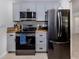 Modern kitchen with stainless steel appliances, stylish gray cabinetry, and butcher block counters at 929 Cypress Ave, Venice, FL 34285