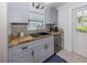 Well-lit kitchen with gray cabinets, butcher block countertops and stainless steel appliances at 929 Cypress Ave, Venice, FL 34285