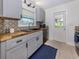 Well-appointed kitchen with modern gray cabinets, stainless steel appliances, and butcher block countertops at 929 Cypress Ave, Venice, FL 34285