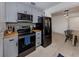 Updated kitchen with sleek stainless steel appliances and neutral color palette at 929 Cypress Ave, Venice, FL 34285