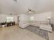 Open concept living area featuring tile floors, a comfortable sectional sofa, and a dining space at 929 Cypress Ave, Venice, FL 34285