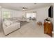 Bright living room with tile flooring, neutral paint, and comfortable seating area at 929 Cypress Ave, Venice, FL 34285