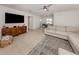 Spacious living room with tile floors, large sectional, a wooden entertainment center, and neutral tones at 929 Cypress Ave, Venice, FL 34285