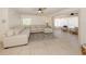 Bright living room with a large sectional sofa, tile floors and lots of natural light at 929 Cypress Ave, Venice, FL 34285
