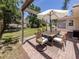 Outdoor patio featuring a dining area with a grill, ideal for entertaining friends and Gathering at 929 Cypress Ave, Venice, FL 34285