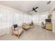 Cozy sun room featuring a ceiling fan, and two armchairs with natural light streaming in at 929 Cypress Ave, Venice, FL 34285