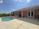 Backyard with pool, hot tub and lush landscaping under a blue sky at 98 Maltby St, Port Charlotte, FL 33953