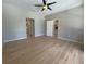 Spacious bedroom with new wood flooring, ceiling fan, and ensuite bathroom at 98 Maltby St, Port Charlotte, FL 33953