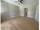 Bright bedroom with new flooring, ceiling fan, and ensuite bathroom access at 98 Maltby St, Port Charlotte, FL 33953