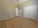 Spacious bedroom featuring wood floors, a ceiling fan, and a large closet with doors at 98 Maltby St, Port Charlotte, FL 33953