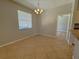 Bright dining area featuring neutral walls, tile floors, and a window with natural light at 98 Maltby St, Port Charlotte, FL 33953