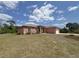 A ranch style home with a beautiful lawn and landscaping at 98 Maltby St, Port Charlotte, FL 33953