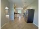 An open-concept kitchen with modern stainless steel appliances and tile flooring at 98 Maltby St, Port Charlotte, FL 33953
