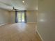 Spacious living room with tile flooring and sliding glass doors to the backyard at 98 Maltby St, Port Charlotte, FL 33953