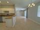 Bright living area with tile flooring adjacent to kitchen with breakfast bar at 98 Maltby St, Port Charlotte, FL 33953