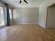 Neutral living room with new flooring, ceiling fan, and natural light from sliding doors at 98 Maltby St, Port Charlotte, FL 33953
