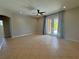 Open-concept living room featuring tile flooring, ceiling fan, and access to other rooms at 98 Maltby St, Port Charlotte, FL 33953