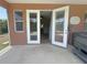 Covered patio with sliding doors leading indoors and a nearby hot tub at 98 Maltby St, Port Charlotte, FL 33953