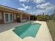 Backyard rectangular pool and hot tub with lush landscaping at 98 Maltby St, Port Charlotte, FL 33953