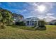 Expansive backyard featuring a tile roof, lush landscaping and screened in patio at 1037 Beckley Cir, Venice, FL 34292