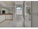 Bright bathroom boasts marble floors, double vanity, soaking tub, and shower with glass doors at 1037 Beckley Cir, Venice, FL 34292