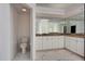 Bright bathroom features marble floors, double vanity, and separate toilet room at 1037 Beckley Cir, Venice, FL 34292