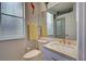 Clean bathroom with light countertops, framed mirror, toilet, and decorative nautical accents at 1037 Beckley Cir, Venice, FL 34292