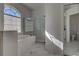 Bright bathroom boasts marble floors, tub under an arched window, and glass shower at 1037 Beckley Cir, Venice, FL 34292