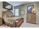 Bedroom with a decorative queen-sized bed, dresser, artwork, and soft carpeting at 1037 Beckley Cir, Venice, FL 34292