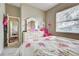 Bedroom with large dresser, pink chair, and large window for natural light at 1037 Beckley Cir, Venice, FL 34292