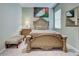 Bedroom with a decorative queen-sized bed, upholstered bench, and soft carpeting at 1037 Beckley Cir, Venice, FL 34292