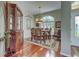 Elegant dining room featuring a wooden table with seating for six, a decorative chandelier, and ample natural light at 1037 Beckley Cir, Venice, FL 34292