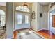 Elegant foyer with hardwood floors, decorative rug, and stylish lighting creating a grand entrance to this beautiful home at 1037 Beckley Cir, Venice, FL 34292