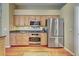 Well-equipped kitchen featuring stainless steel appliances, granite countertops and custom cabinetry at 1037 Beckley Cir, Venice, FL 34292