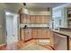 Spacious kitchen with ample cabinetry, granite countertops, and hardwood floors leading to adjacent living spaces at 1037 Beckley Cir, Venice, FL 34292