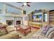Bright living room with a fireplace, custom entertainment center and comfortable seating at 1037 Beckley Cir, Venice, FL 34292