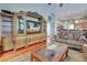 Living room with an entertainment center, hardwood floors and views into the kitchen at 1037 Beckley Cir, Venice, FL 34292